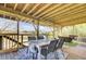 Screened in porch featuring a dining table, wicker furniture, and views of the marsh at 1481 Battery Reynolds Ct, Charleston, SC 29412