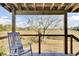 The covered back porch features a rocking chair with views of the surrounding landscape at 1481 Battery Reynolds Ct, Charleston, SC 29412