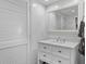 Clean bathroom features a white vanity with storage, a large mirror, and a louvered door at 1502 Marsh Haven, Seabrook Island, SC 29455