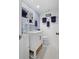 Charming bathroom features white hexagon tile floor, vanity with storage, and blue patterned wallpaper at 1502 Marsh Haven, Seabrook Island, SC 29455