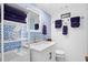 Stylish bathroom features patterned wallpaper, a white vanity, and neatly arranged purple towels at 1502 Marsh Haven, Seabrook Island, SC 29455