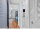 Hallway view of a charming bedroom with blue patterned wallpaper, white doors, and hardwood floors at 1502 Marsh Haven, Seabrook Island, SC 29455