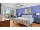 Bright bedroom with view to balcony, ceiling fan, and soothing blue walls at 1502 Marsh Haven, Seabrook Island, SC 29455