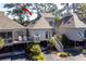 A charming home with a deck and stairs leading to the yard, nestled among mature trees at 1502 Marsh Haven, Seabrook Island, SC 29455
