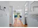 Inviting hallway featuring hardwood floors and a glimpse into the living room with a blue chair at 1502 Marsh Haven, Seabrook Island, SC 29455