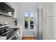 Kitchen featuring stainless steel appliances, marble countertop, white cabinetry and natural lighting at 1502 Marsh Haven, Seabrook Island, SC 29455