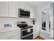 Bright kitchen features white cabinetry, stainless steel appliances, marble backsplash, and natural light at 1502 Marsh Haven, Seabrook Island, SC 29455
