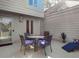 Cozy outdoor patio featuring a dining set and lounge chair, perfect for enjoying al fresco meals and relaxation at 1502 Marsh Haven, Seabrook Island, SC 29455