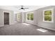 Sunny bedroom includes a walk-in closet, neutral walls, and plush gray carpet at 1518 Stanwick Dr, Johns Island, SC 29455