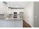 Kitchen featuring white cabinets, granite countertops, stainless steel appliances, pendant lighting, and a door to the side at 1518 Stanwick Dr, Johns Island, SC 29455