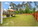 Expansive backyard with a patio seating area and mature trees at 153 Caleb Ct, Ladson, SC 29456