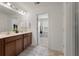 Spacious bathroom featuring double vanity, framed mirror, and view to walk-in closet at 153 Caleb Ct, Ladson, SC 29456