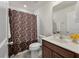 Cozy bathroom featuring a vanity with dark cabinets and a shower with patterned curtain at 153 Caleb Ct, Ladson, SC 29456