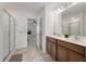 Bathroom features a double sink vanity, framed mirror, tiled floor, and glass enclosed shower at 153 Caleb Ct, Ladson, SC 29456