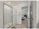 Bathroom featuring enclosed glass shower, light tile flooring, and access to bedroom at 153 Caleb Ct, Ladson, SC 29456