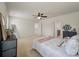 Bedroom with beige carpet, ceiling fan, a picture window, and access to the ensuite bathroom at 153 Caleb Ct, Ladson, SC 29456