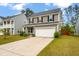 Charming two-story home with a spacious driveway and well-maintained lawn at 153 Caleb Ct, Ladson, SC 29456