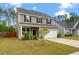 Two-story home featuring neutral siding, black shutters, an attached two-car garage, and landscaping at 153 Caleb Ct, Ladson, SC 29456