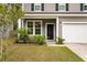 Charming two-story home with a well-manicured lawn, tidy landscaping and a one car garage at 153 Caleb Ct, Ladson, SC 29456