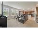 Bright living room with large sectional couch, plush carpet, and windows with natural light at 153 Caleb Ct, Ladson, SC 29456