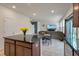 Open concept view from the kitchen into the living room with TV and a dining table at 153 Caleb Ct, Ladson, SC 29456