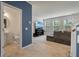 Open living area with a view of the powder room, featuring a television and large windows at 153 Caleb Ct, Ladson, SC 29456