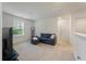 Living room features a comfy blue sofa, TV, and natural light from the window at 153 Caleb Ct, Ladson, SC 29456