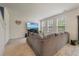Living room features a large sectional couch, plush carpet, and three windows for ample natural light at 153 Caleb Ct, Ladson, SC 29456