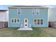 Home's backyard features a small patio area with chairs and a well-maintained lawn at 1541 Homecoming Blvd, Ravenel, SC 29470