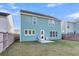 Home exterior with a green-blue facade, back patio, and a well-maintained lawn at 1541 Homecoming Blvd, Ravenel, SC 29470