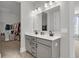 Bright bathroom with double sink vanity, white countertops, modern fixtures, and a walk-in closet at 1541 Homecoming Blvd, Ravenel, SC 29470