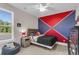 Bright bedroom with a colorfully painted accent wall, beanbag chair, and modern furnishings at 1541 Homecoming Blvd, Ravenel, SC 29470