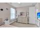 Bedroom features a large dresser, sheer curtains, and a view of a mounted TV at 1541 Homecoming Blvd, Ravenel, SC 29470
