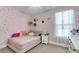 Cozy bedroom with decorative polka dot accent wall, sheer curtains, and plush decor at 1541 Homecoming Blvd, Ravenel, SC 29470