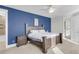 This bedroom features a dark wood bedroom set, a modern ceiling fan, and a bright blue accent wall at 1541 Homecoming Blvd, Ravenel, SC 29470