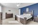 This bedroom features a dark wood bedroom set, a modern ceiling fan, and a blue accent wall at 1541 Homecoming Blvd, Ravenel, SC 29470