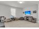 Spacious bonus room with beige carpet, natural light, and a wall-mounted TV perfect for entertaining at 1541 Homecoming Blvd, Ravenel, SC 29470
