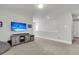Spacious bonus room with beige carpet, natural light, and a wall-mounted TV at 1541 Homecoming Blvd, Ravenel, SC 29470