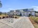 Exterior view of the community clubhouse featuring covered walkways and manicured landscaping at 1541 Homecoming Blvd, Ravenel, SC 29470