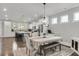 Elegant dining room with stylish chandelier and views of the kitchen at 1541 Homecoming Blvd, Ravenel, SC 29470