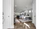 Open-concept dining area with modern light fixture, seamlessly connected to the kitchen with island seating at 1541 Homecoming Blvd, Ravenel, SC 29470