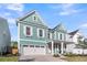 Charming two-story home with a covered front porch, a two-car garage, and landscaped yard at 1541 Homecoming Blvd, Ravenel, SC 29470