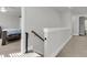 Upstairs hallway featuring a bedroom entrance, stairway, and white walls at 1541 Homecoming Blvd, Ravenel, SC 29470