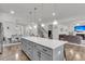 An island kitchen that overlooks living room and dining room areas, creating a warm, welcoming space at 1541 Homecoming Blvd, Ravenel, SC 29470