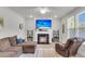 Bright living room featuring a fireplace with mounted TV and comfortable seating arrangement with natural light at 1541 Homecoming Blvd, Ravenel, SC 29470
