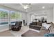 Spacious living room with large windows, providing ample natural light, and comfortable, neutral-toned furniture at 1541 Homecoming Blvd, Ravenel, SC 29470