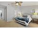 Bright bedroom with a cozy bed, ceiling fan, and neutral color scheme at 177 Sugar Magnolia Way, Charleston, SC 29414