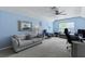 Well-lit bonus room with vaulted ceiling, cozy seating, and a dedicated workspace at 177 Sugar Magnolia Way, Charleston, SC 29414