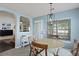Cozy dining area with a modern light fixture and large window with blinds at 177 Sugar Magnolia Way, Charleston, SC 29414