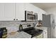 Kitchen showcasing stainless steel microwave and oven over black glasstop range at 177 Sugar Magnolia Way, Charleston, SC 29414